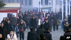 FILE - In this image made from video, pedestrians brave the cold as the make their way through an open square, Jan. 30, 2020, in Pyongyang, North Korea. 