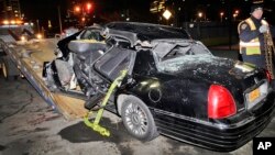 A police officer tows a car following an accident in New York that killed longtime "60 Minutes" correspondent Bob Simon, Wednesday, Feb. 11, 2015.