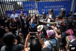 FILE - Journalists protest outside the Supreme Court, in Guatemala City, March 4, 2023. The journalists rejected a judge's order calling for the investigation of nine journalists from El Periodico newspaper.