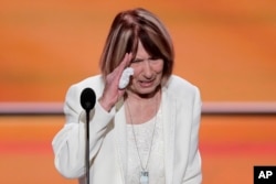 Pat Smith, mother of Benghazi victim Sean Smith, salutes after speaking during the opening day of the Republican National Convention in Cleveland, July 18, 2016.