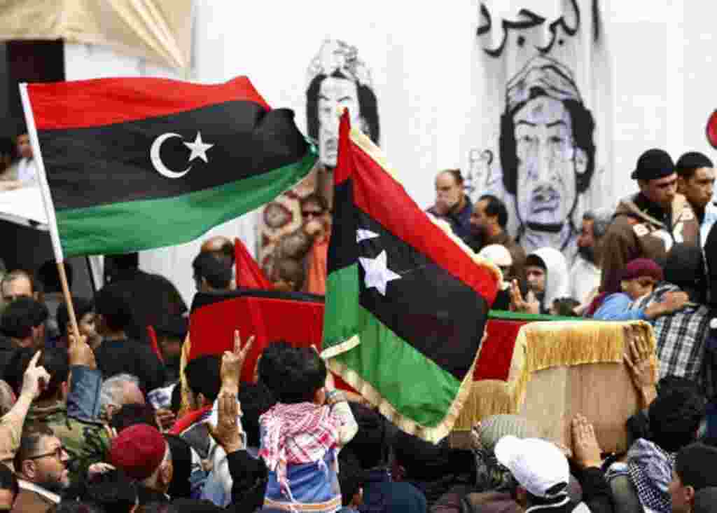 Mourners carry the coffin of a man killed in yesterday's NATO air strike on rebel vehicles on the road between Ajdabiyah and Brega, during Friday prayers in Benghazi, April 8, 2011