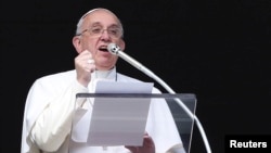 FILE - Pope Francis delivers his Sunday Angelus prayer in Saint Peter's Square at the Vatican, Feb. 1 2015. 