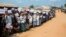Rohingya refugees holding placards await the arrival of a U.N. Security Council team at the Kutupalong Rohingya refugee camp in Kutupalong, Bangladesh, April 29, 2018. A U.N. Security Council team visiting Bangladesh promised Sunday to work hard to resolve a crisis involving hundreds of thousands of Rohingya Muslims who have fled to the country to escape military-led violence in Myanmar. 