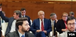 FILE - U.S. Special Representative for Afghanistan Reconciliation Zalmay Khalilzad, center, with red tie, attends the opening of the intra-Afghan dialogue before leaving Afghans to talk among themselves, in Doha, Qatar, July 7, 2019. (A. Tanzeem/VOA)