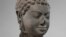 FILE - This December 2005 photo shows a 7th century sculpture titled "Head of Buddha" at the Metropolitan Museum of Art in New York. The sculpture is one of 16 pieces of artwork that the museum said it will return to Cambodia and Thailand.