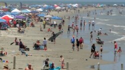 People gather on the beach for the Memorial Day weekend in Port Aransas, Texas, May 23, 2020. Beachgoers are being urged to practice social distancing to guard against COVID-19.