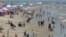 People gather on the beach for the Memorial Day weekend in Port Aransas, Texas, May 23, 2020. Beachgoers are being urged to practice social distancing to guard against COVID-19.