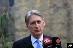FILE - Philip Hammond, then the British foreign secretary, speaks at a press conference at the British embassy in Baghdad, Iraq, March 16, 2016.