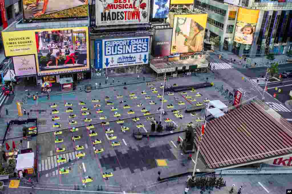 Overhead view of yogis participating in Solstice in Times Square: Mind Over Madness Yoga &ndash; an annual all-day outdoor yoga event in New York.