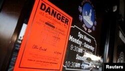 An order from the town of Jupiter is shown in the front window of the Orchids of Asia Day Spa in Jupiter, Florida, Feb. 22, 2019. 