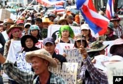 FILE - Thai farmers march through the street during a rally to put pressure on the Office of the Anti-Corruption Commission in Bangkok, Thailand, Feb. 7, 2014.