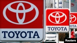 FILE - Toyota Motor signboards are displayed at a dealer's shop in Yokohama, south of Tokyo. The recall involves Toyota's popular RAV4 and RAV4 electric models produced between 2005 and 2014.