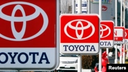 FILE - Toyota Motor signboards are displayed at a dealer's shop in Yokohama, south of Tokyo.