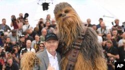 Director Ron Howard, from left, and a person wearing a costume of the character Chewbacca pose for photographers during a photo call for the film 'Solo: A Star Wars Story' at the 71st international film festival, Cannes, southern France, May 15, 2018. 