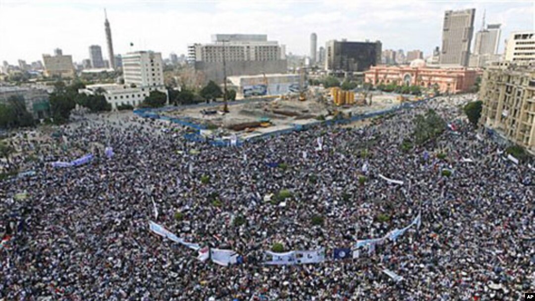 Thousands of Egyptians protest in Cairo's central Tahrir Square, the focal point of Egyptian uprising, as they hold banners and signs demanding prosecution of ousted president Hosni Mubarak and his regime Friday, April 8, 2011