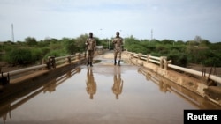 Members of Amhara special forces stand guard on the Tekeze river bridge near Ethiopia-Eritrean border near the town of Humera, Ethiopia, July 1, 2021.