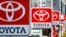 FILE -Toyota Motor signboards are displayed at a dealer's shop in Yokohama, south of Tokyo.