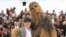 Director Ron Howard, from left, and a person wearing a costume of the character Chewbacca pose for photographers during a photo call for the film 'Solo: A Star Wars Story' at the 71st international film festival, Cannes, southern France, May 15, 2018. 