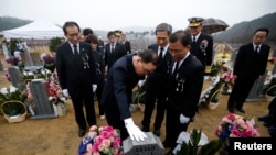 South Korean Prime Minister Jung Hong-won, center, pays respects at the grave of a sailor killed in the 2010 sinking of the Cheonan at National Cemetery, Daejeon, March 26, 2014.