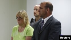 Joyce Mitchell, accused of smuggling contraband into the prison from which two convicts escaped last week, stands with her attorney, Keith Bruno, as she is arraigned in City Court in Plattsburgh, New York, June 12, 2015. 