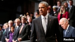 President Barack Obama and Vice President Joe Biden, right, arrive at the armed services farewell in honor of Defense Secretary Chuck Hagel at Joint Base Myer-Henderson Hall in Virginia, Jan. 28, 2015.