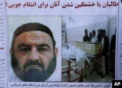 FILE - An Afghan newspaper headlines pictures of the former leader of the Afghan Taliban, Mullah Akhtar Mansoor, who was killed in a U.S. drone strike on May 21, 2016.