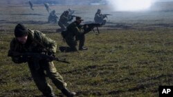 FILE - Pro-Russian rebels are seen conducting exercises near Yenakiyeve in the Donetsk region of eastern Ukraine, March 2015.