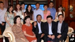 FILE PHOTO - Former Thai Prime Minister Thaksin Shinawatra, second right from the front row, and Cambodian Prime Minister Hun Sen, center, pose for photographs with other members of Hun Sen's family in his residence in Phnom Penh, Cambodia.