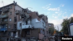 Rescuers work at a site of a residential building hit by a Russian missile strike in Kharkiv, Ukraine, on May 31, 2024.