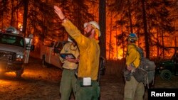 Firefighters prepare to battle the Wolverine wildfire near Chelan, Washington, in this U.S. Forest Service picture taken Aug. 16, 2015.