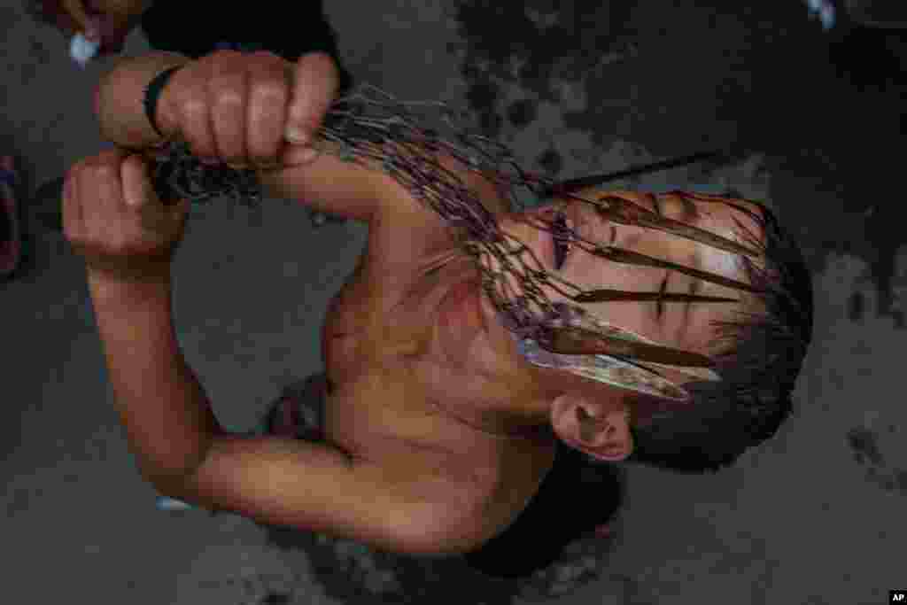 A Kashmiri Shi'ite Muslim boy flagellates himself as he participates in an Ashura procession, the tenth day of Muharram, in Srinagar, Indian-controlled Kashmir.