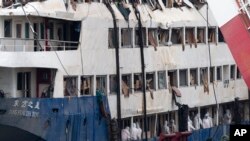 FILE - In this June 7, 2015 photo, rescuers search for passengers' belongings on the raised capsized ship Eastern Star on the Yangtze River in Jianli county of southern China’s Hubei province.