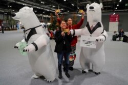 Anti-nuclear activists stand next to inflated polar bears holding banners advocating for nuclear energy as a solution for climate change during the U.N. climate change conference (COP25) in Madrid, Dec. 4, 2019.