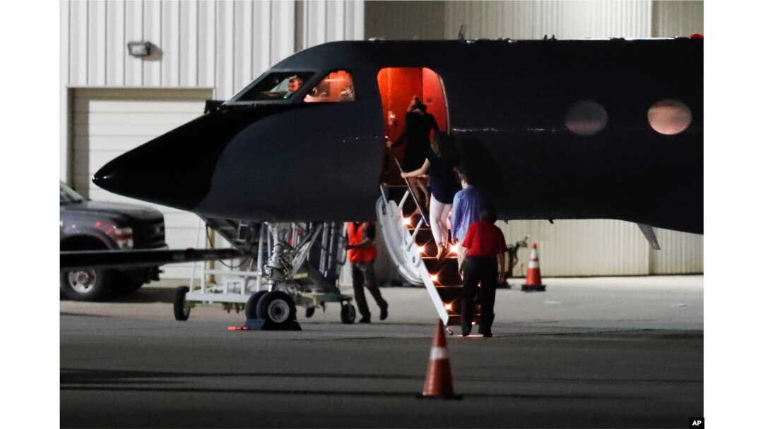 Visitors and medical personnel enter a transport plane carrying Otto Warmbier, before he is transferred to an ambulance at Lunken regional airport, June 13, 2017, in Cincinnati, Ohio.