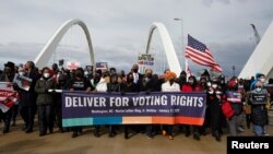 U.S. civil rights activists hold a Peace Walk on the Frederick Douglass Memorial Bridge to urge Democrats to pass a law protecting voting rights, during Martin Luther King Jr. Day, in Washington, Jan. 17, 2022.