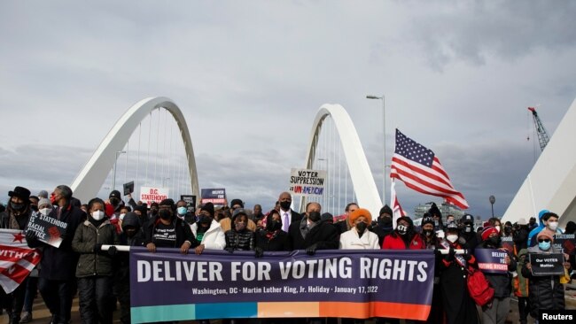 U.S. civil rights activists hold a Peace Walk on the Frederick Douglass Memorial Bridge to urge Democrats to pass a law protecting voting rights, during Martin Luther King Jr. Day, in Washington, Jan. 17, 2022.