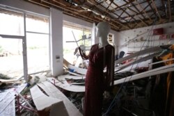 A mannequin inside a shop damaged by shelling during fighting over the breakaway region of Nagorno-Karabakh in Agdam, Azerbaijan, Oct. 1, 2020.