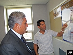 Purdue graduate student Mirwais Rahimi, from Herat Province, presents his research findings to Afghanistan's Minister of Agriculture Asif Rahimi (no relation).