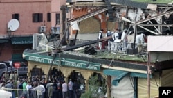 Investigators work at the scene of an explosion which rocked the Argana cafe in Marrakesh's Jamaa el-Fnaa square, April 28, 2011