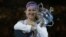 Victoria Azarenka of Belarus hugs her trophy after winning the women's final against China's Li Na at the Australian Open tennis championship in Melbourne, Australia, January 26, 2013.