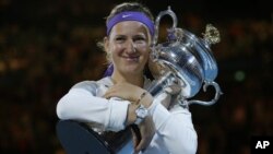 Victoria Azarenka of Belarus hugs her trophy after winning the women's final against China's Li Na at the Australian Open tennis championship in Melbourne, Australia, January 26, 2013.