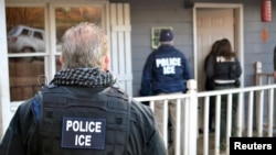 FILE - U.S. Immigration and Customs Enforcement officers conduct a targeted enforcement operation in Atlanta, Georgia, Feb. 9, 2017. 
