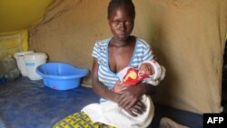 A woman from the Central African Republic (CAR) holds her baby in a refugee camp set up by the UNHCR in Nangungue, eastern Cameroon, April 12, 2013.