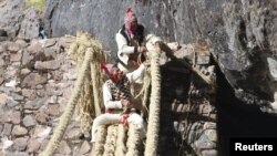 Members of the Huinchiri community rebuild an Incan hanging bridge, known as the Qeswachaka bridge, using traditional weaving techniques in Canas, Peru, June 13, 2021. 