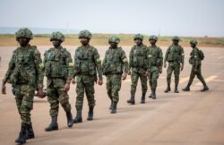 Rwandan armed forces prepare to board a flight at the airport in Kigali to Mozambique, July 10, 2021, to help battle an Islamic extremist insurgency.