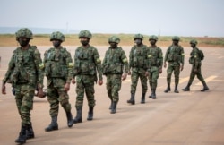 Rwandan armed forces prepare to board a flight at the airport in Kigali to Mozambique, July 10, 2021, to help battle an Islamic extremist insurgency.