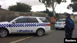 FILE - Australian police search what is believed to be the home of gunman Yacqub Khayre, who was shot dead by police on Monday after he shot a man dead and held a woman hostage, in the Melbourne suburb of Roxburgh Park in Australia, June 6, 2017. 