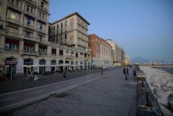 FILE - A street is almost empty in downtown Naples, southern Italy, March 11, 2020.