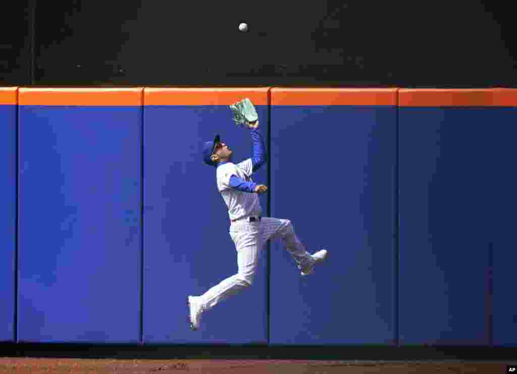 New York Mets center fielder Albert Almora Jr. makes a leaping catch during the sixth inning of a baseball game against the Washington Nationals at Citi Field, April 25, 2021, in New York.