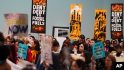 FILE - Activists participate in a demonstration against fossil fuels at the COP29 U.N. Climate Summit, in Baku, Azerbaijan, Nov. 16, 2024.